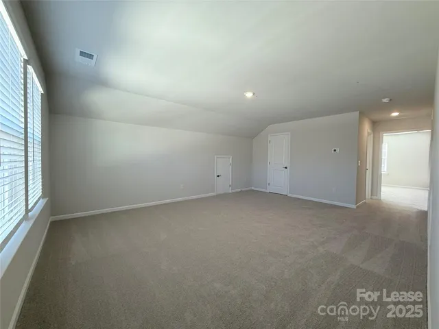 an empty room with a empty space and windows