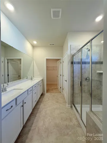 a bathroom with a shower sink and mirror