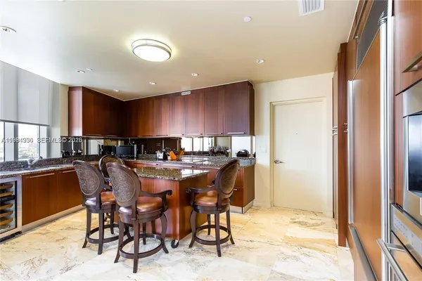a kitchen with stainless steel appliances granite countertop sink stove top oven and cabinets