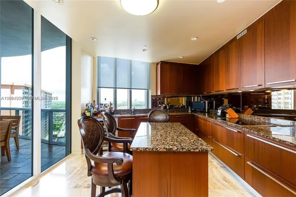 a living room with furniture a rug and kitchen countertops