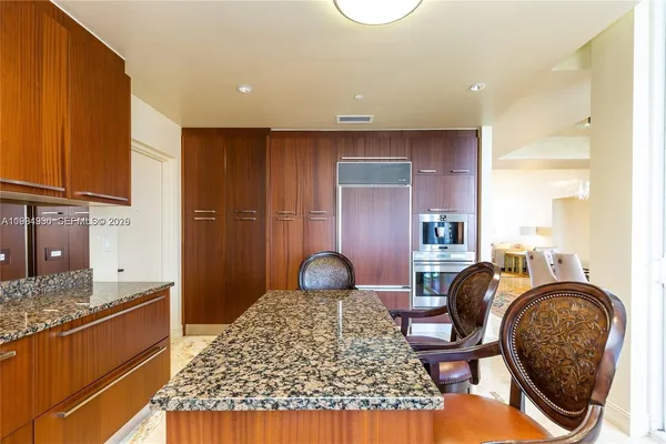 a dining room with furniture and a large window