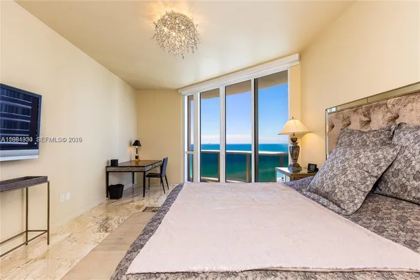 a bedroom with a bed and flat screen tv