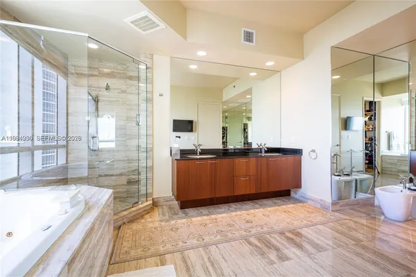 a view of a bathroom with a sink and a mirror