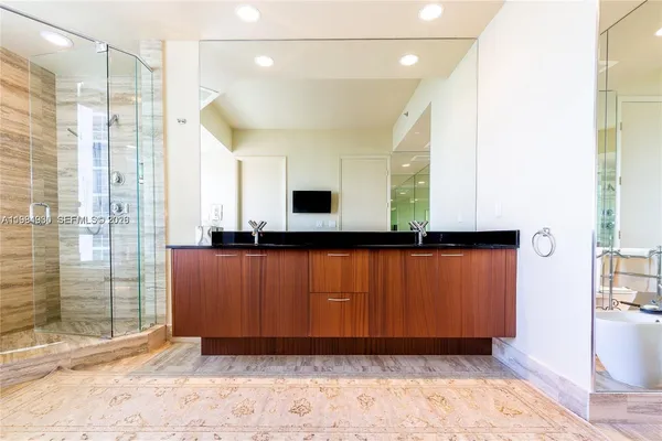 a bathroom with a toilet and a mirror