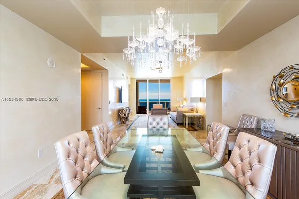 a living room with furniture chandelier and a chandelier