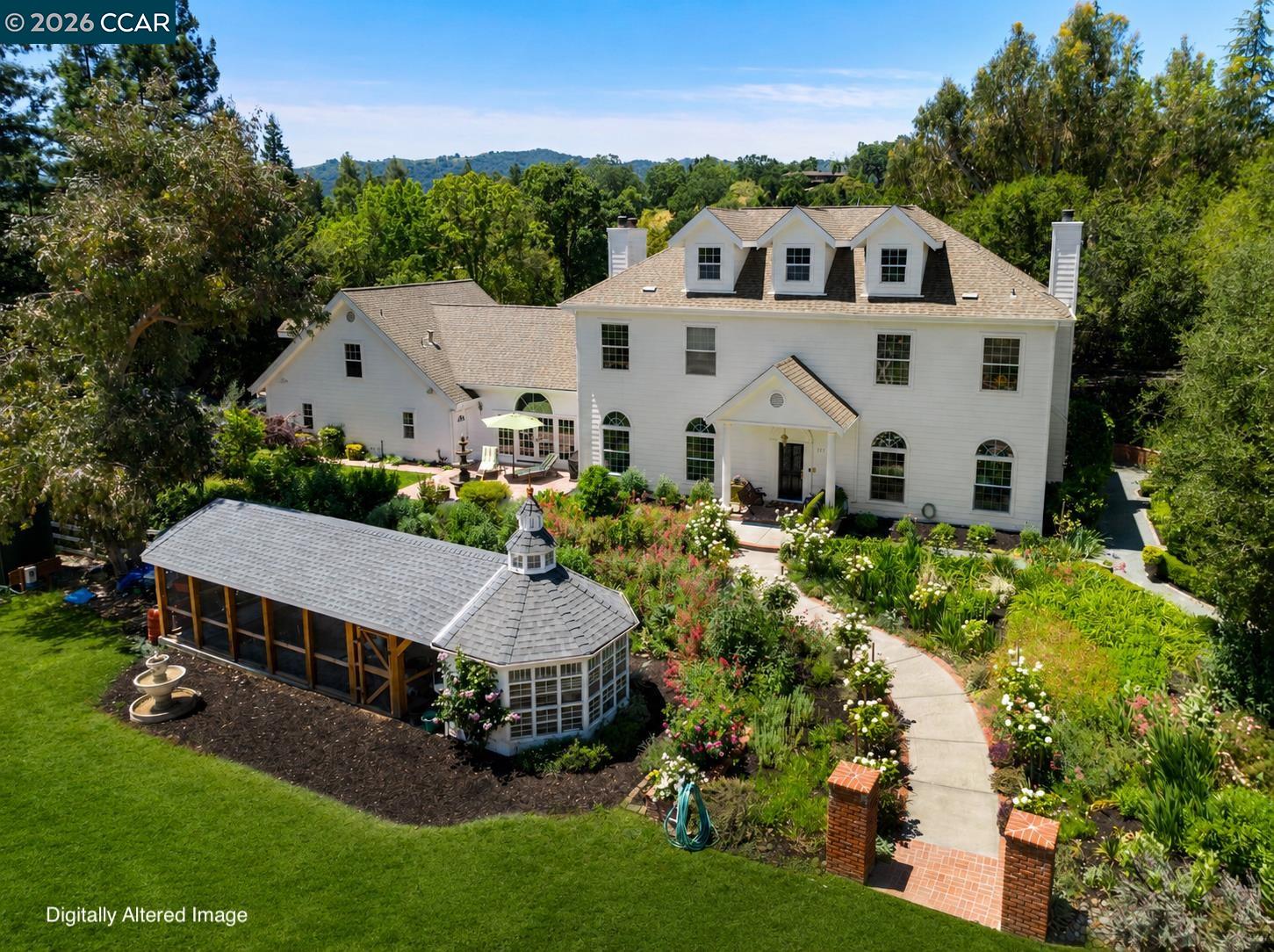 177 Oak Road Alamo, CA 94507 - Photo 45 of 85 a aerial view of a white house with a yard and table and chairs under an umbrella
