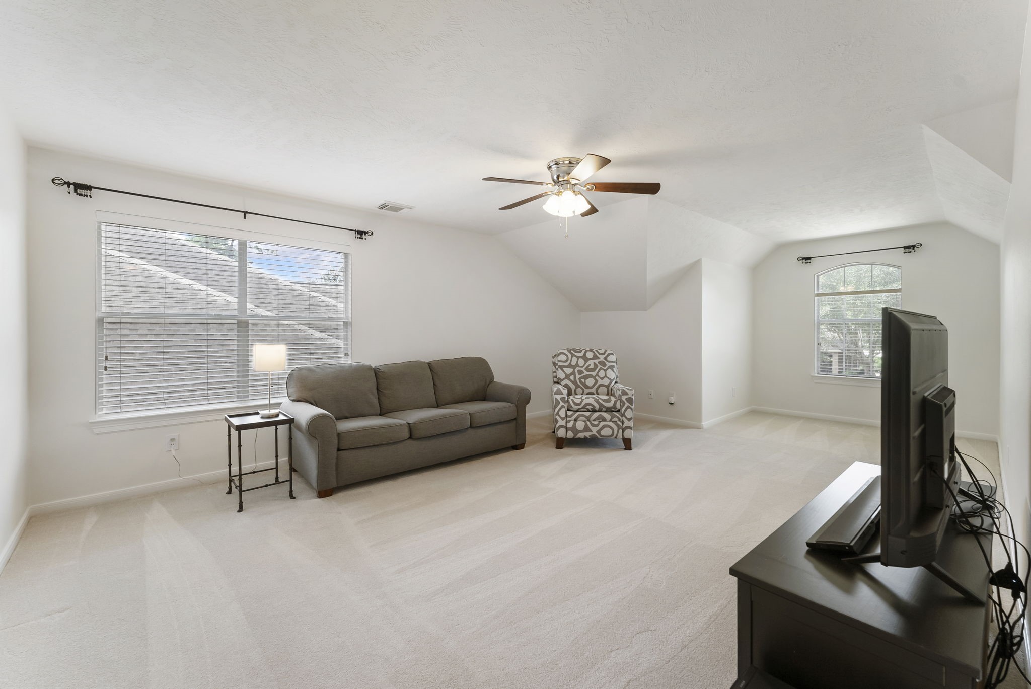 6643 Knollbridge Lane Spring, TX 77379 - Photo 20 of 50 Awesome gameroom upstairs features upgraded carpet, vaulted ceililng with ceiling fan and multiple windows for excellent natural light.
