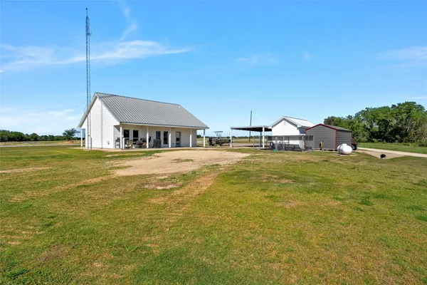 a kitchen with stainless steel appliances granite countertop a refrigerator a stove and a sink with wooden floor
