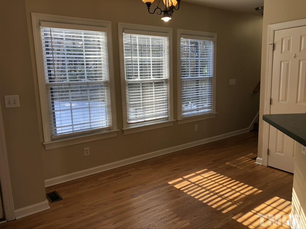 200 Oak Pine Drive Apex, NC 27502 - Photo 14 of 26 a view of an empty room with wooden floor and a window