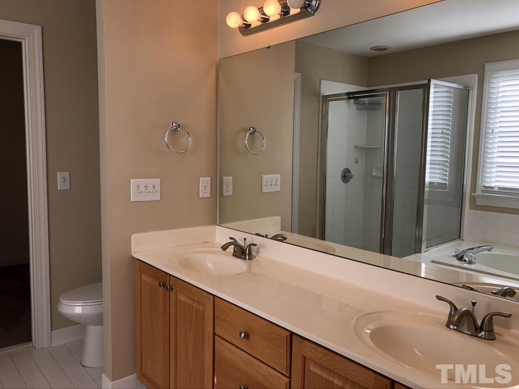 200 Oak Pine Drive Apex, NC 27502 - Photo 18 of 26 a bathroom with a sink and a mirror