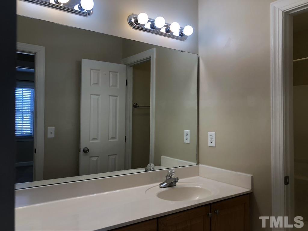200 Oak Pine Drive Apex, NC 27502 - Photo 22 of 26 a bathroom with a sink and a mirror