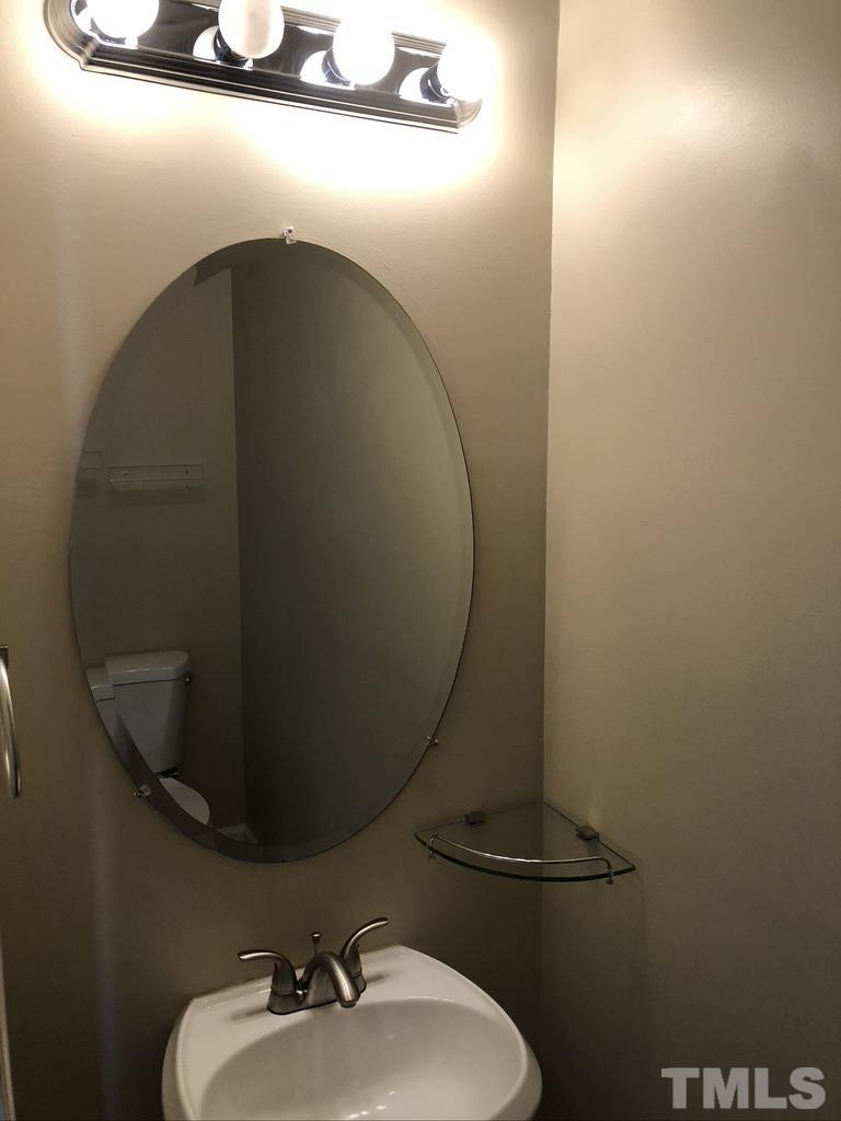 200 Oak Pine Drive Apex, NC 27502 - Photo 7 of 26 a bathroom with a sink and mirror