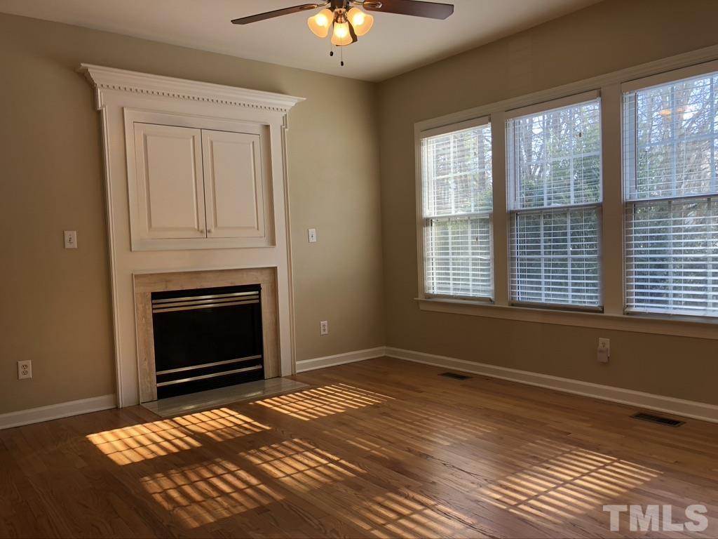200 Oak Pine Drive Apex, NC 27502 - Photo 8 of 26 a bedroom with a bed and a fireplace