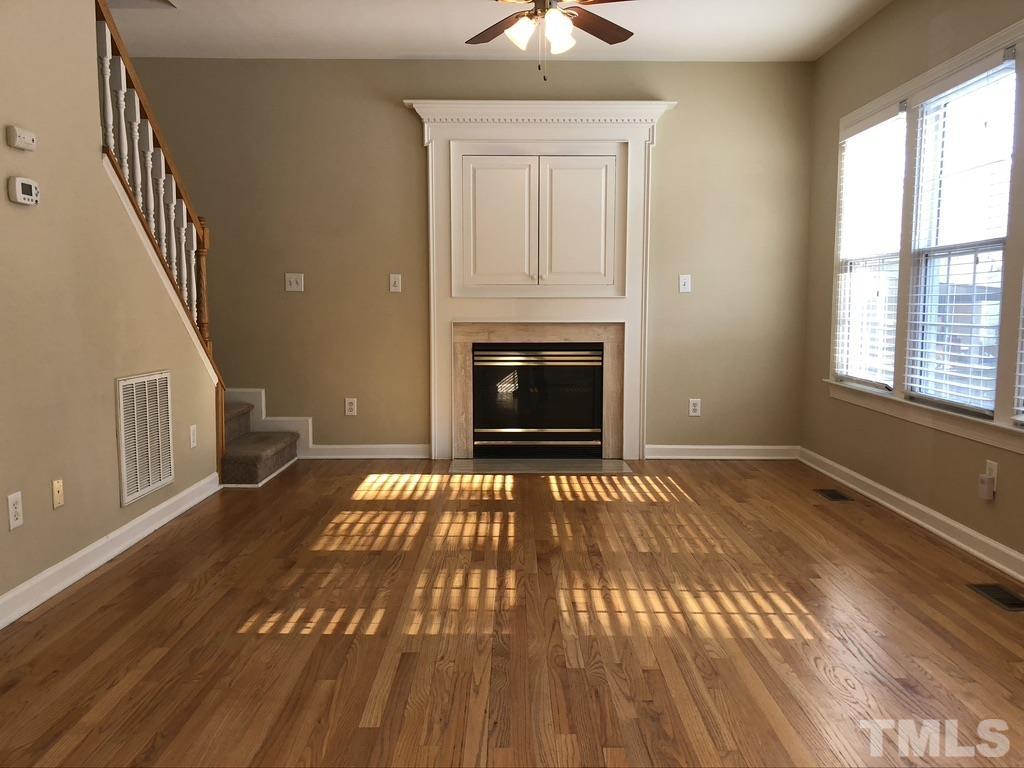 200 Oak Pine Drive Apex, NC 27502 - Photo 9 of 26 wooden floor fireplace and windows in an empty room
