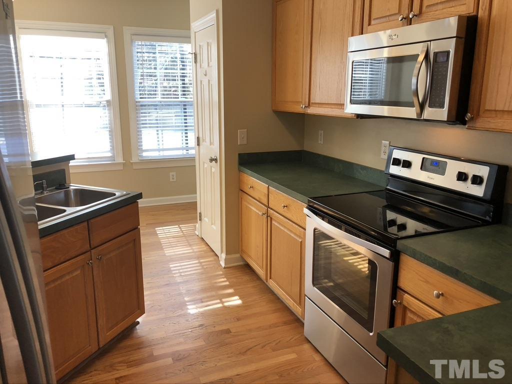 200 Oak Pine Drive Apex, NC 27502 - Photo 10 of 26 a kitchen with stainless steel appliances granite countertop a stove a sink and a microwave
