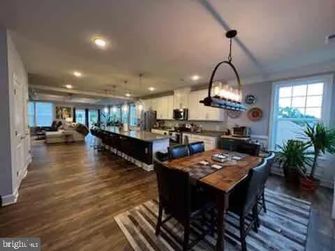 a dining room with furniture a wooden floor and a chandelier