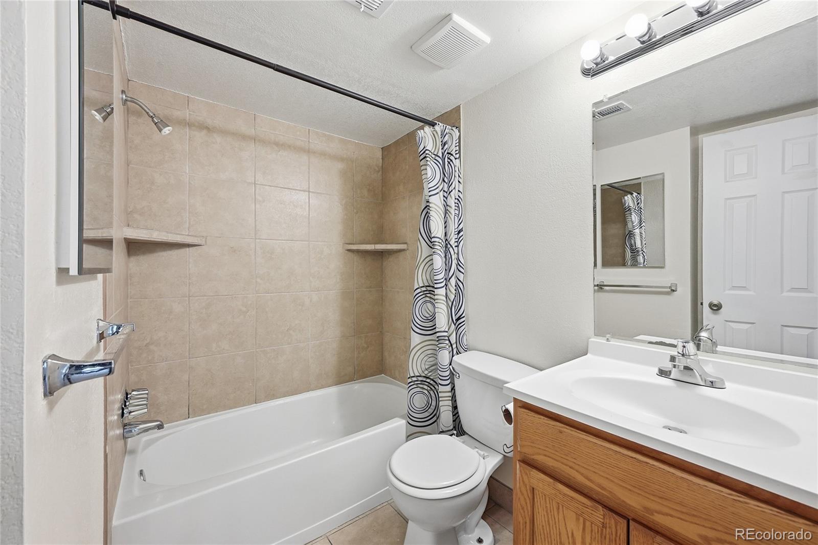 1885 South Quebec Way, Unit A18 Denver, CO 80231 - Photo 12 of 31 a bathroom with a sink toilet and shower