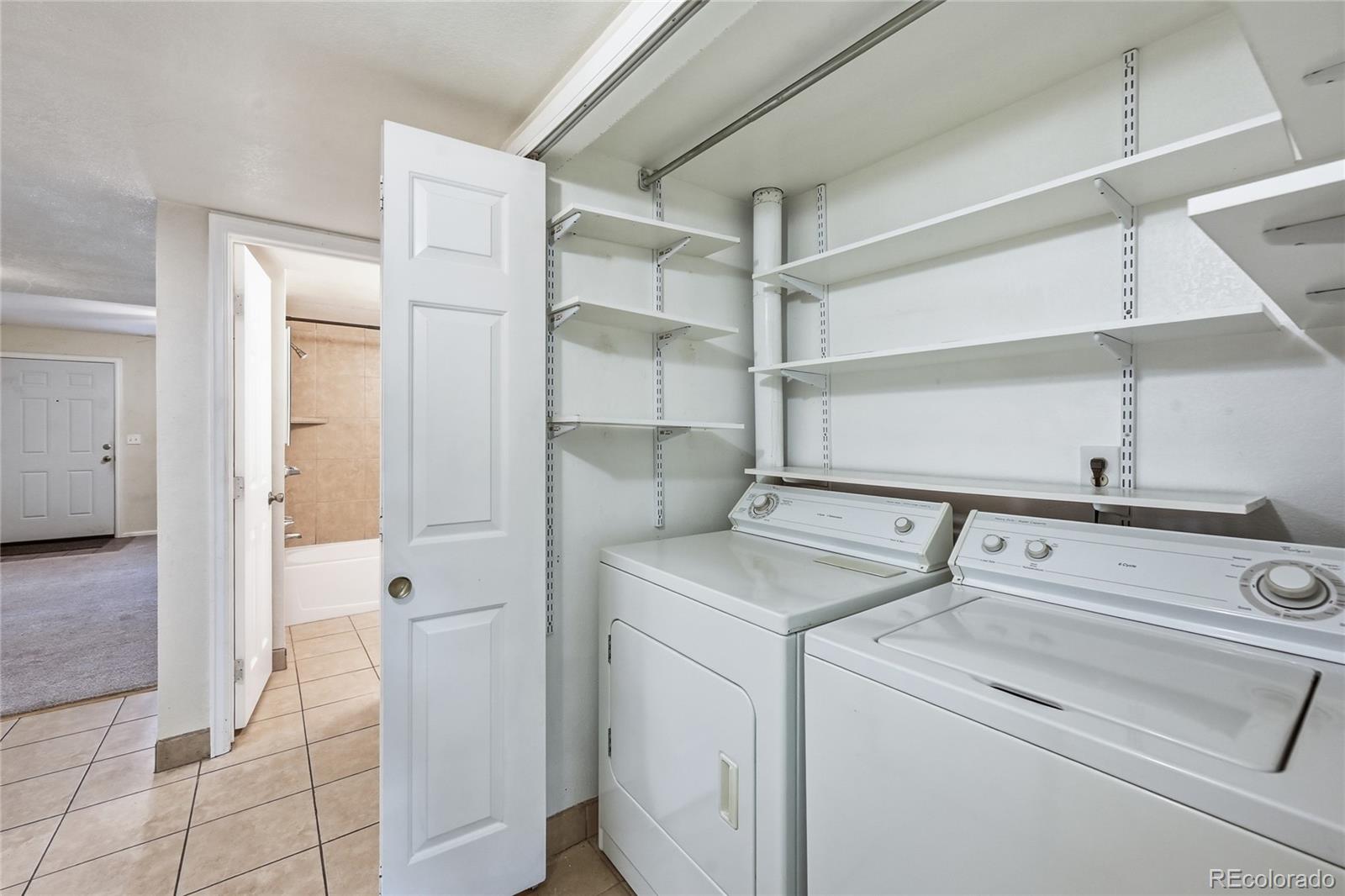 1885 South Quebec Way, Unit A18 Denver, CO 80231 - Photo 15 of 31 a utility room with dryer and washer