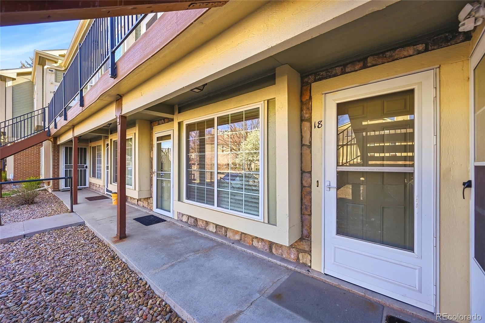 1885 South Quebec Way, Unit A18 Denver, CO 80231 - Photo 3 of 31 a view of a porch with a table and chairs