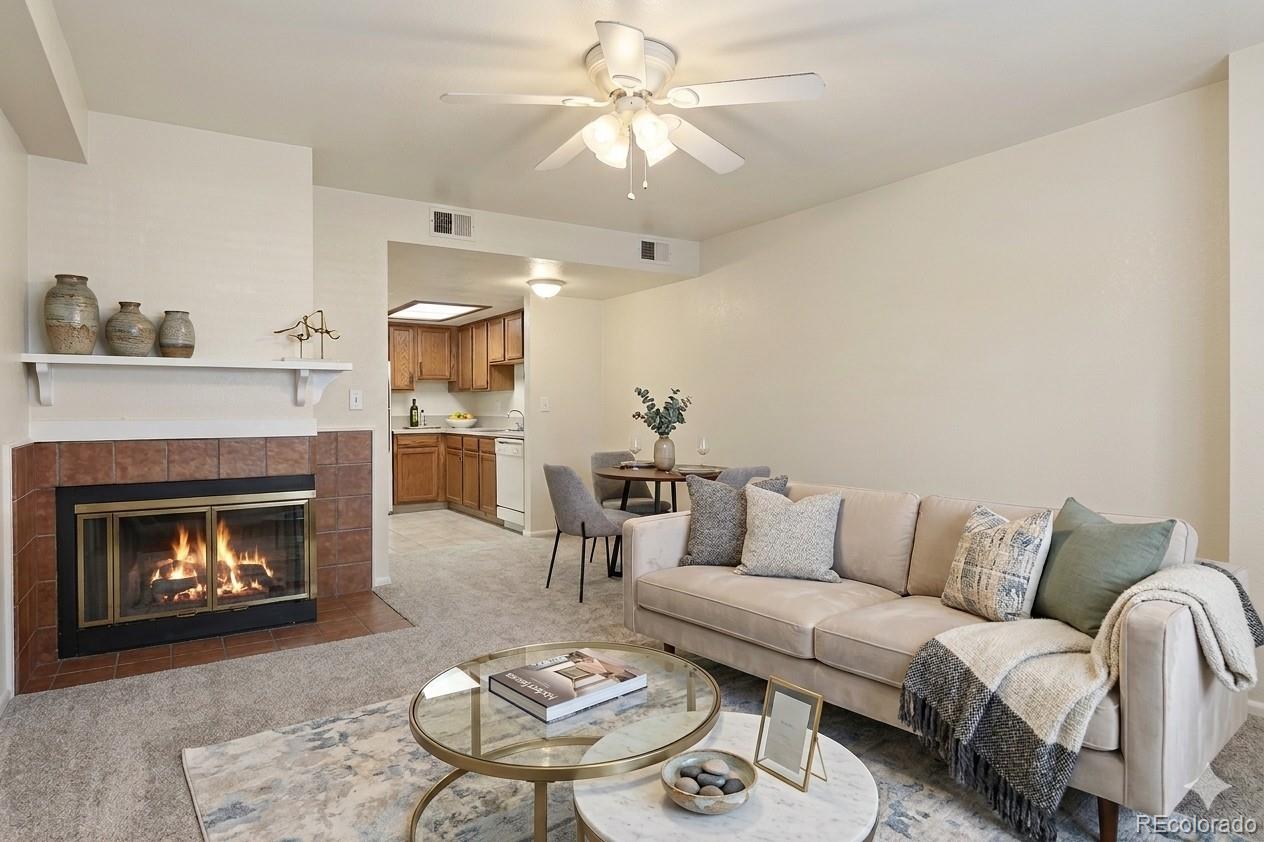 1885 South Quebec Way, Unit A18 Denver, CO 80231 - Photo 4 of 31 a living room with furniture and a fireplace