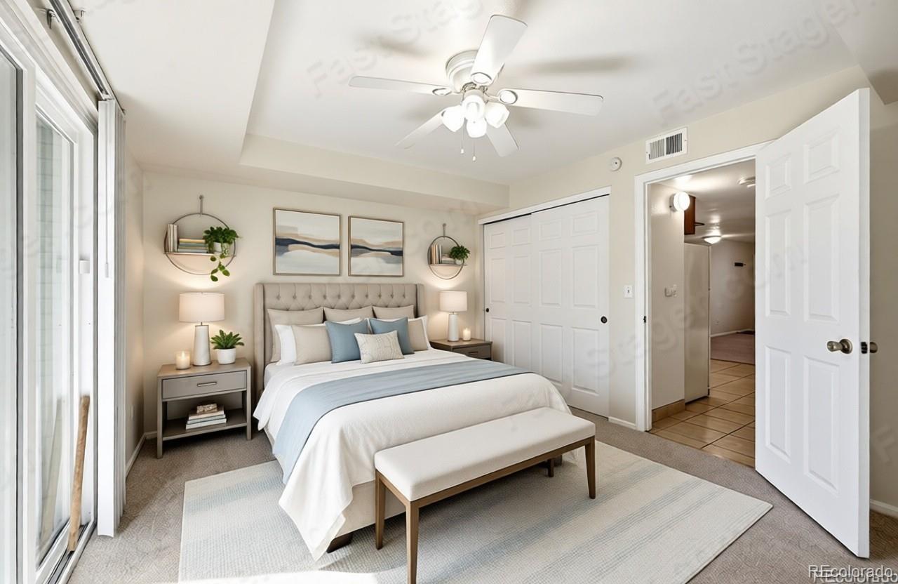 1885 South Quebec Way, Unit A18 Denver, CO 80231 - Photo 5 of 31 a bedroom with a bed and a chandelier