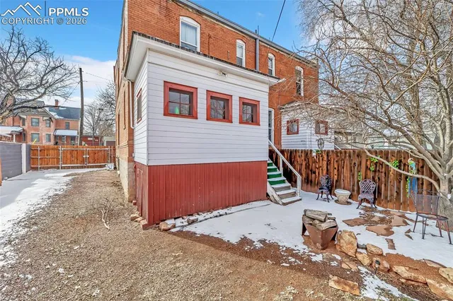 a view of a backyard with a large tree