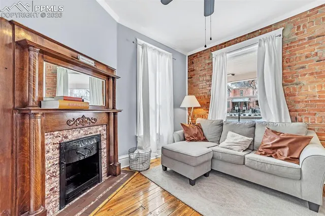 a view of a livingroom with furniture window and wooden floor