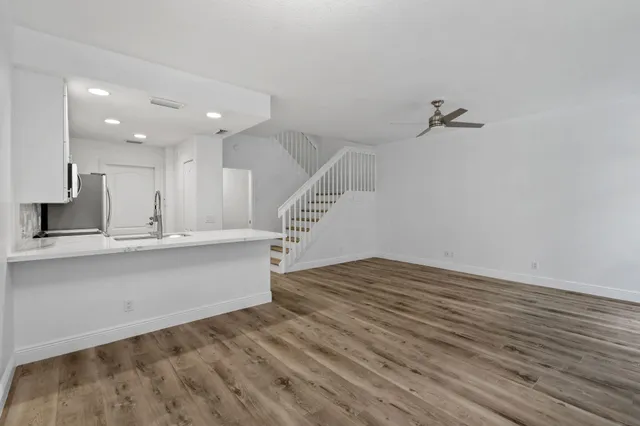a kitchen with a sink a counter top space cabinets and stainless steel appliances