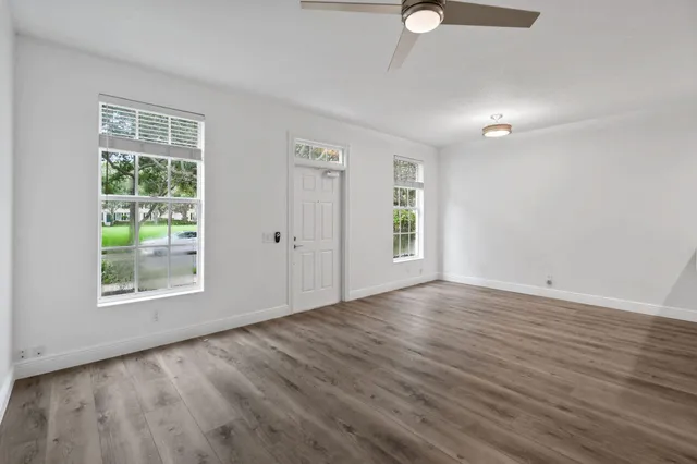 a kitchen with stainless steel appliances white cabinets white stove a microwave and a refrigerator
