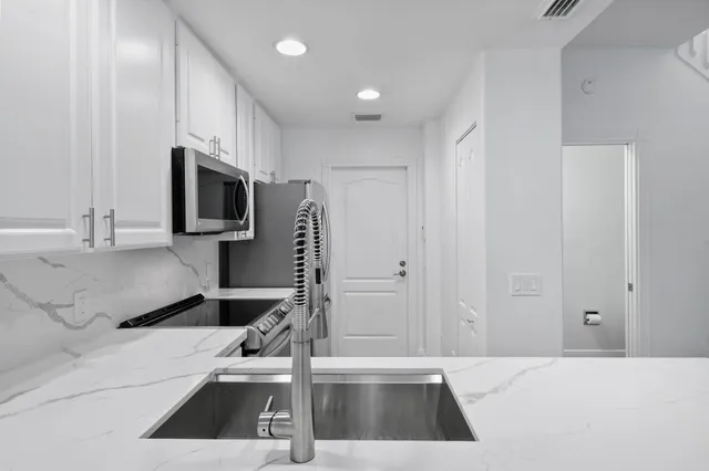 a kitchen that has a sink and a stove in it