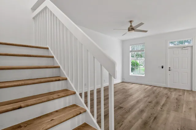a view of a hallway with wooden floor