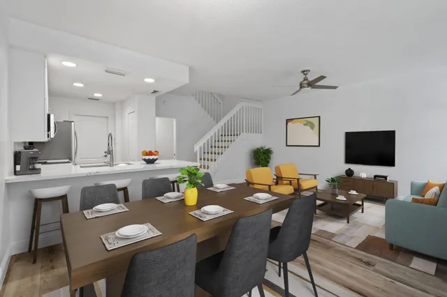 a view of a dining room with furniture and wooden floor