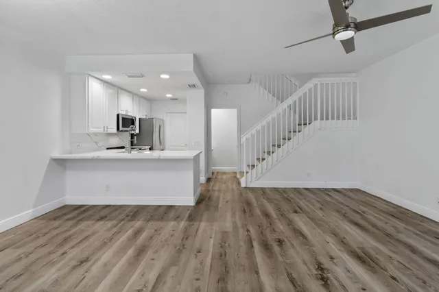 a view of kitchen and hall with wooden floor