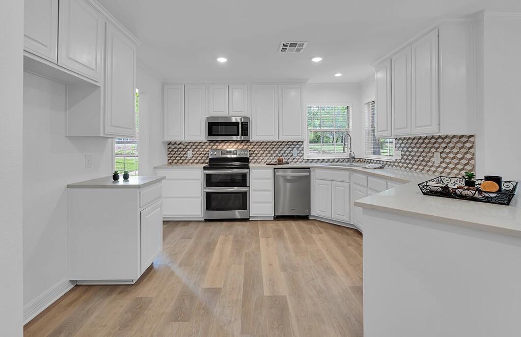 1068 Brazos Bluff Drive China Spring, TX 76633 - Photo 11 of 40 a kitchen with a sink cabinets and stainless steel appliances