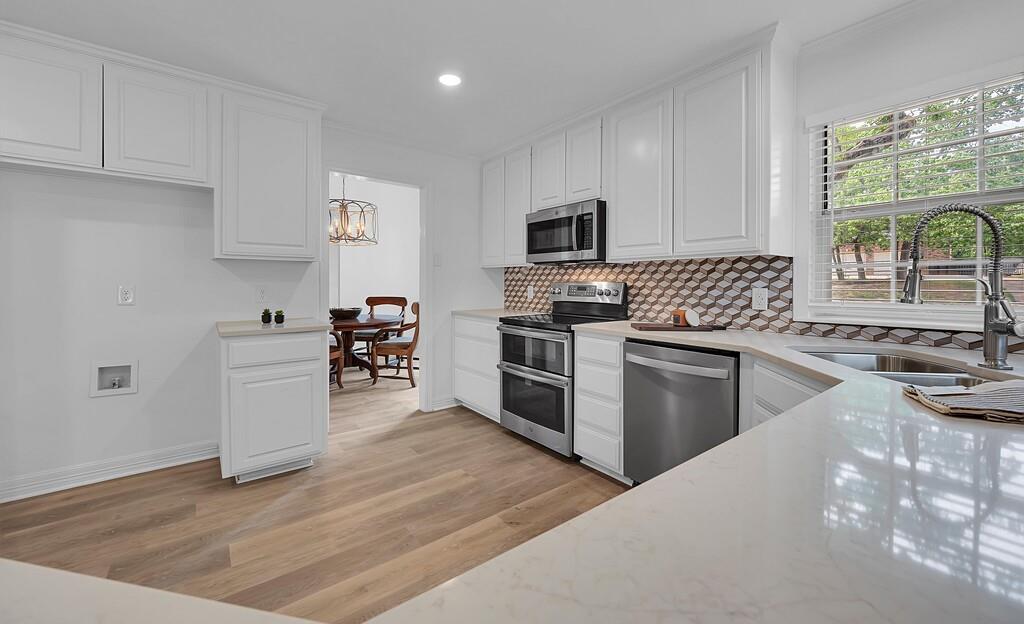 1068 Brazos Bluff Drive China Spring, TX 76633 - Photo 12 of 40 a kitchen with granite countertop a sink cabinets and stainless steel appliances