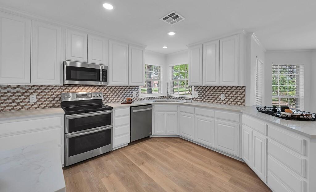 1068 Brazos Bluff Drive China Spring, TX 76633 - Photo 13 of 40 a kitchen with a sink stove and microwave