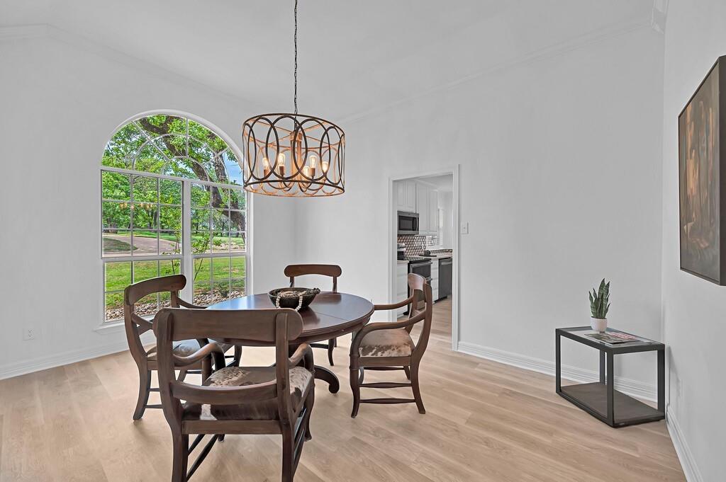 1068 Brazos Bluff Drive China Spring, TX 76633 - Photo 20 of 40 a view of a dining room with furniture wooden floor and chandelier