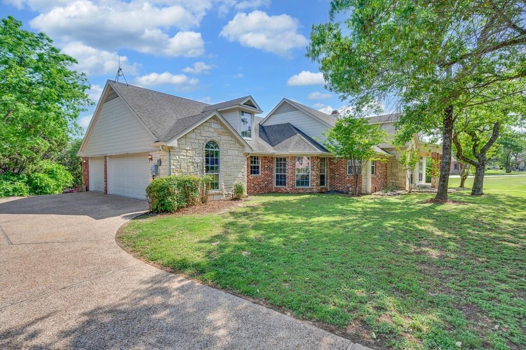 1068 Brazos Bluff Drive China Spring, TX 76633 - Photo 35 of 40 a front view of a house with a garden