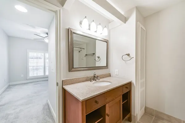 an empty room with closet and a chandelier fan