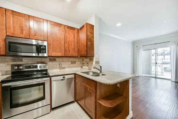 a kitchen with a sink appliances and cabinets