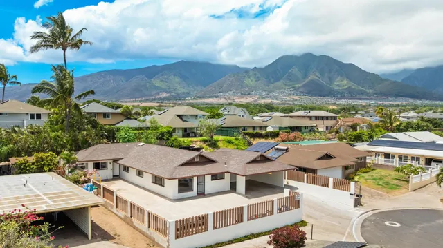 an aerial view of residential houses with outdoor space and parking