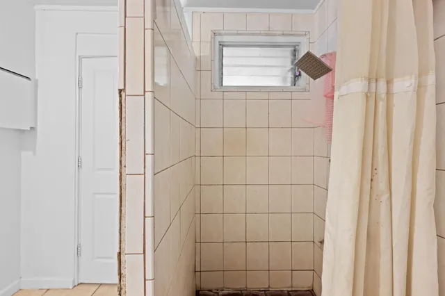 a bathroom with a toilet a sink and shower