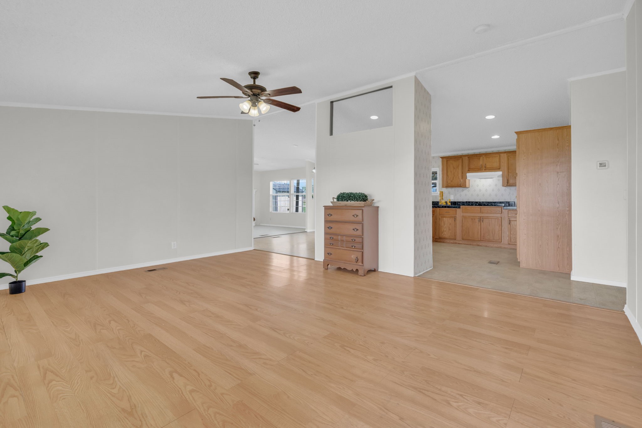 37038 Bell Road Waller, TX 77484 - Photo 11 of 43 a view of empty room with wooden floor and kitchen view