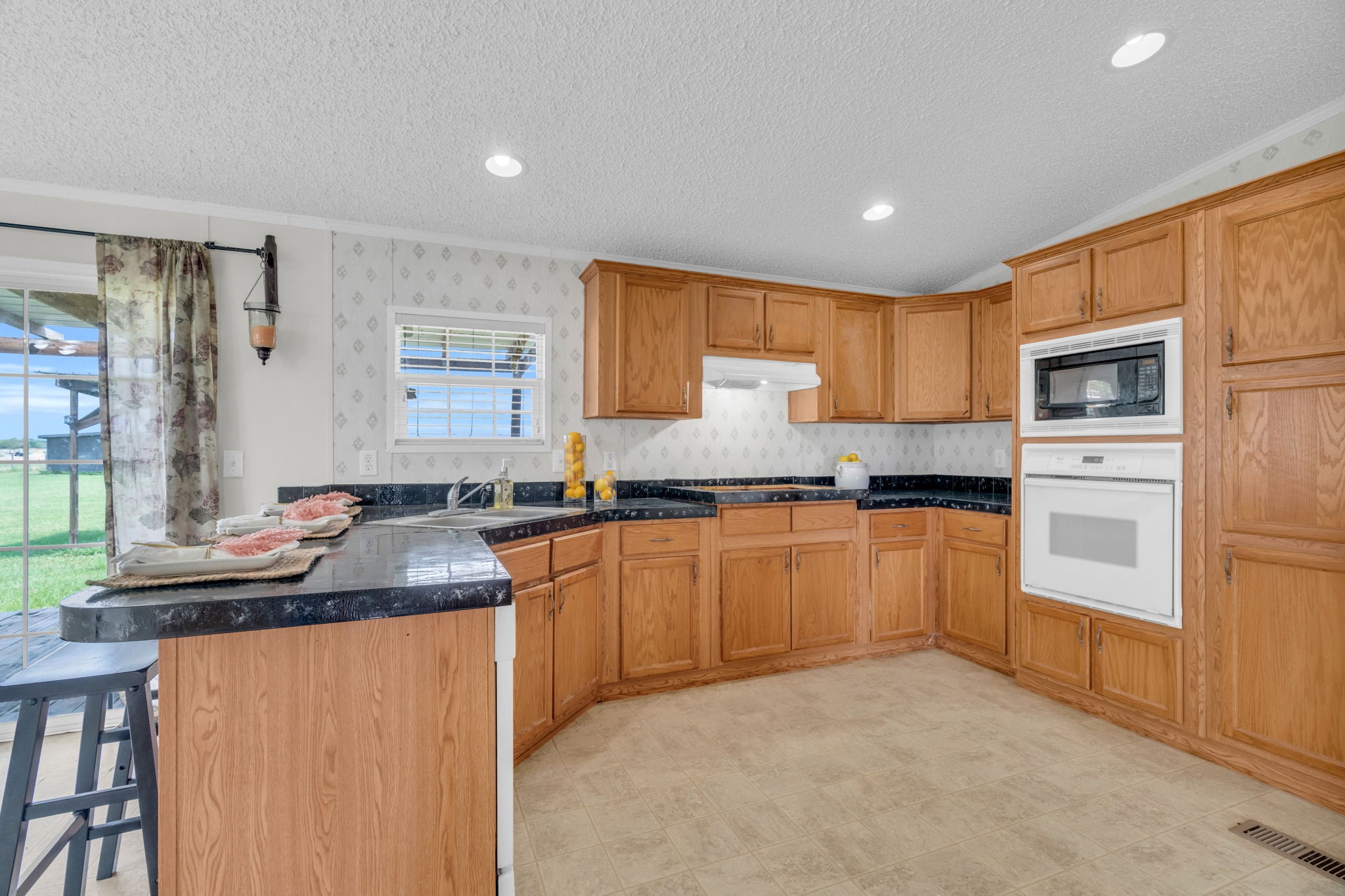 37038 Bell Road Waller, TX 77484 - Photo 15 of 43 a kitchen with granite countertop a sink stove and cabinets