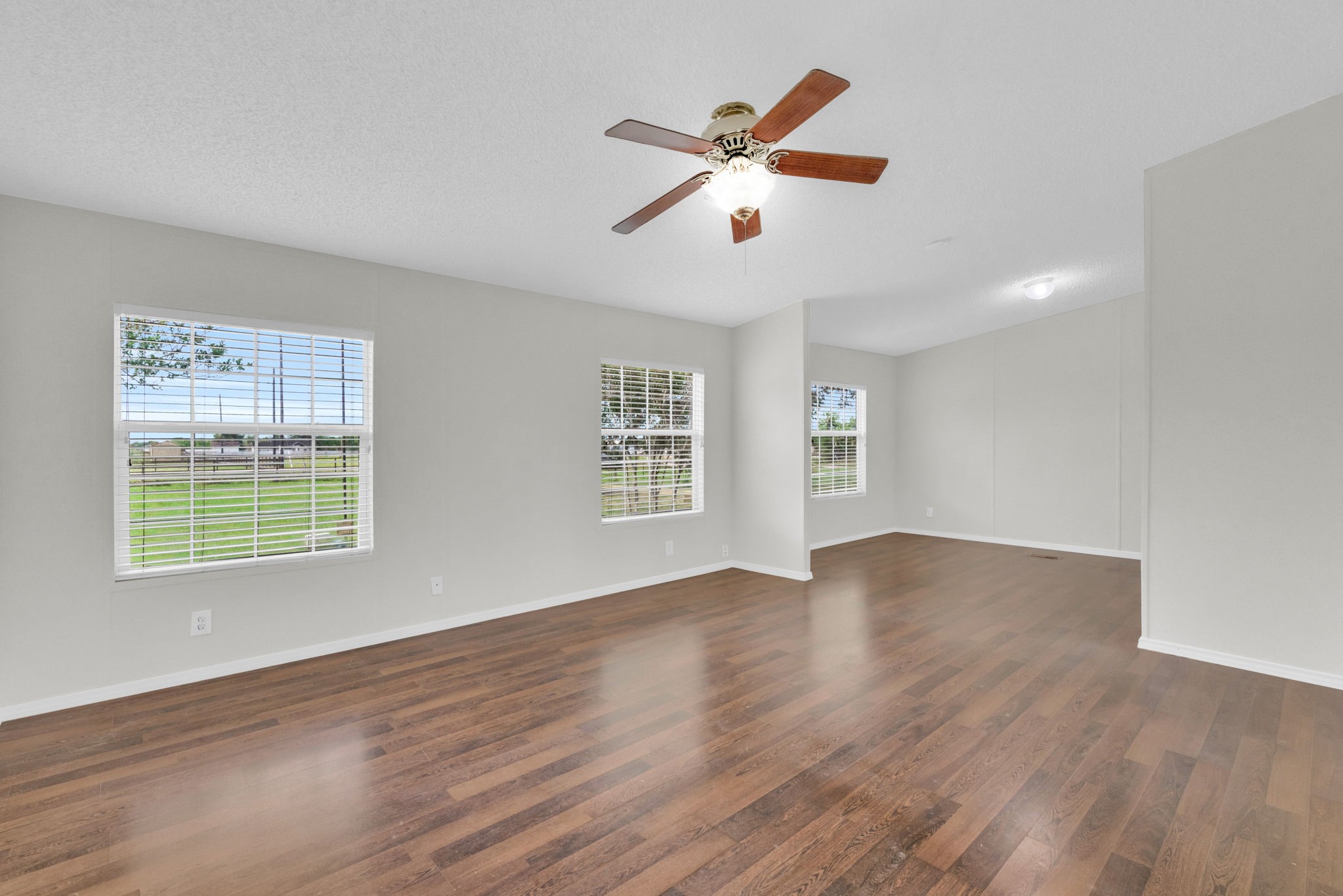 37038 Bell Road Waller, TX 77484 - Photo 22 of 43 a view of an empty room with wooden floor and a window