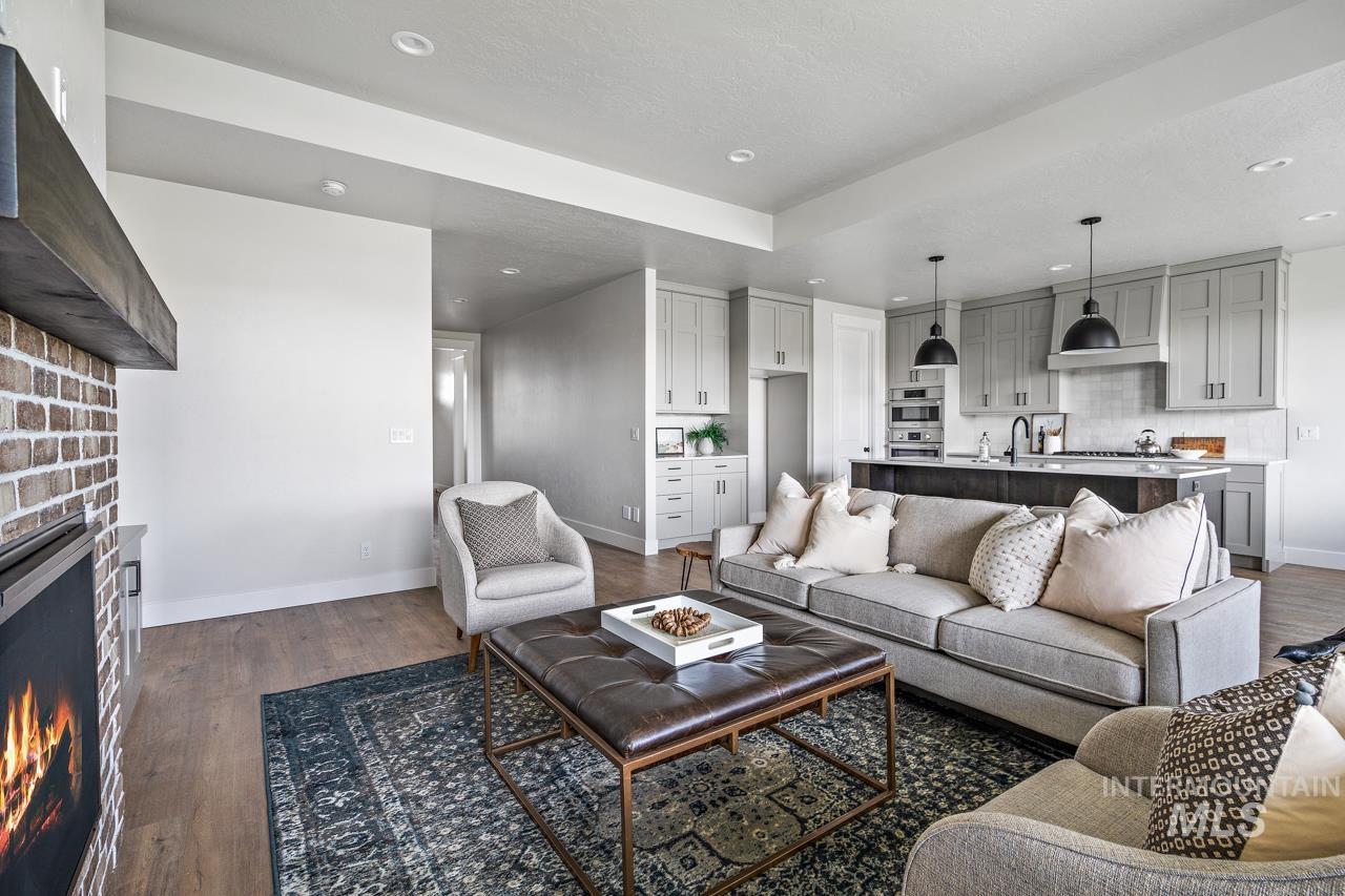 1101 East Crescendo Street Meridian, ID 83642 - Photo 5 of 31 Living room with dark wood-style floors, a fireplace, and recessed lighting