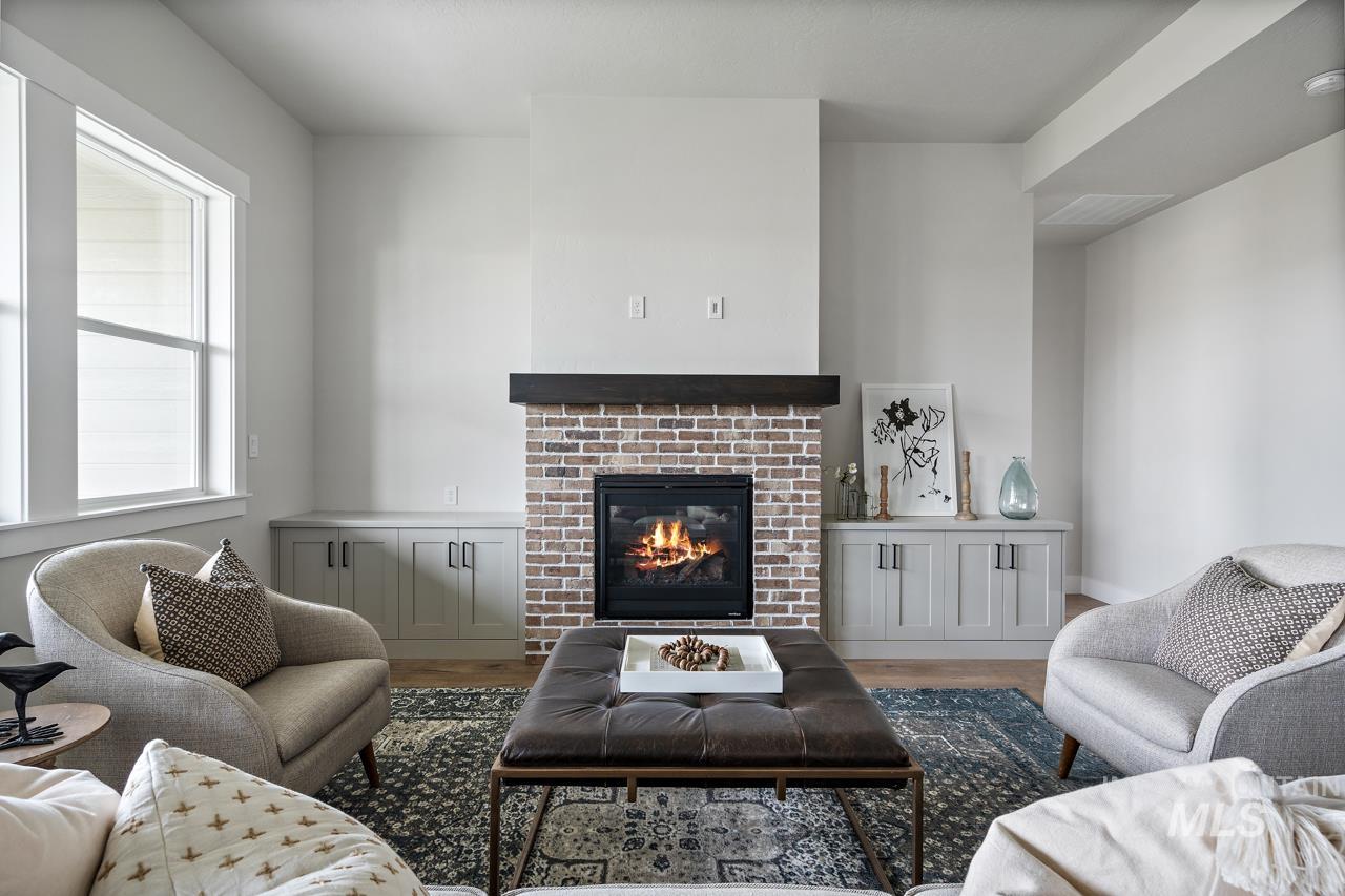 1101 East Crescendo Street Meridian, ID 83642 - Photo 7 of 31 Living area with a fireplace and wood finished floors