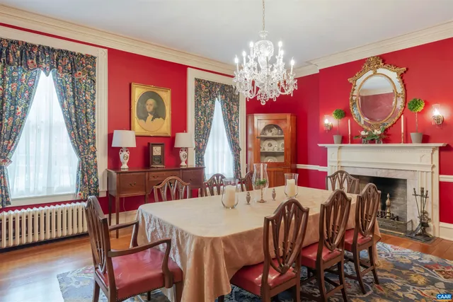 a view of a dining room with furniture a chandelier and wooden floor