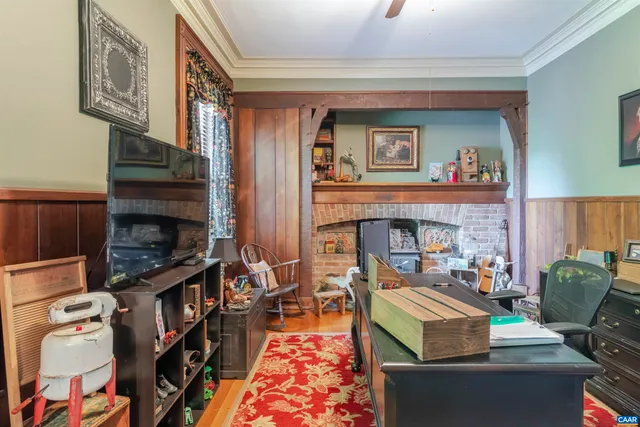 a living room with furniture a fireplace and a flat screen tv