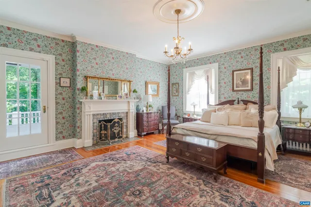 a spacious bedroom with bed and a fireplace